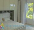 bedroom with modern bed and cupboard wall behind the bed