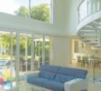 overview main floor with the glass wall, view to the pool and high ceiling