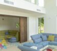 Double living area with blue and green sofas
