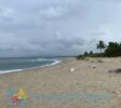 Pristine beach just 50 meters from the developed lot for sale in La Boca, Dominican Republic. Featuring crystal-clear waters and golden sand. Listed by The Realty Group