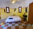 Studio Building: A two-level structure with five well-appointed studios, each with a kitchenette, full bathroom, and private terrace, ideal for guest comfort
