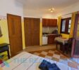 Studio Building: A two-level structure with five well-appointed studios, each with a kitchenette, full bathroom, and private terrace, ideal for guest comfort