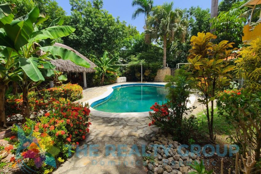 Relax by the beautiful kidney-shaped pool, just a minute