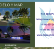 Entrance to Cielo y Mar community showcasing Puerto Plata land for sale with cobblestone roads and tropical landscaping