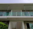Front view of gated building in Sosúa condos for sale with tropical landscaping