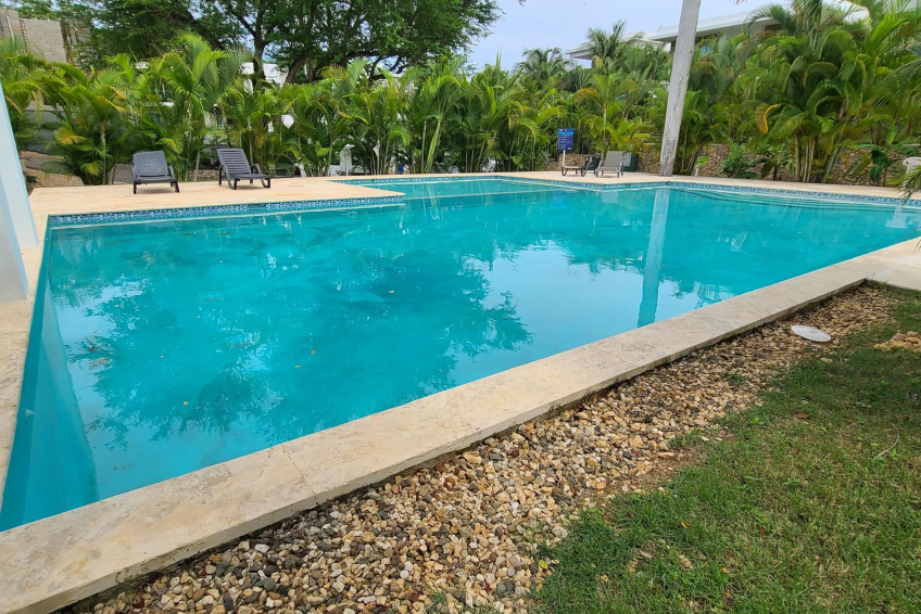 Large shared pool in gated Sosúa condos for sale perfect for leisure and guests