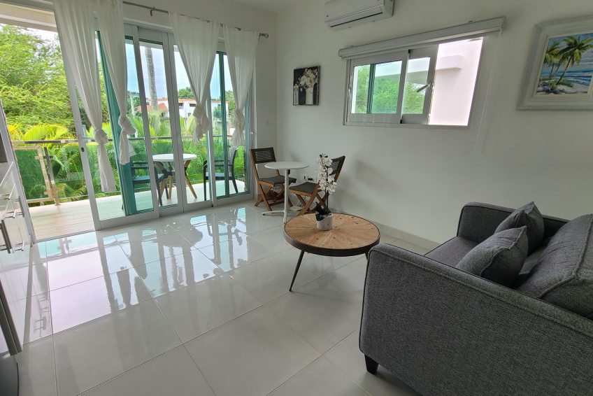 Open-concept living and kitchen space in Sosúa condos for sale with modern appliances and cozy layout