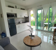 Open-concept living and kitchen space in Sosúa condos for sale with modern appliances and cozy layout