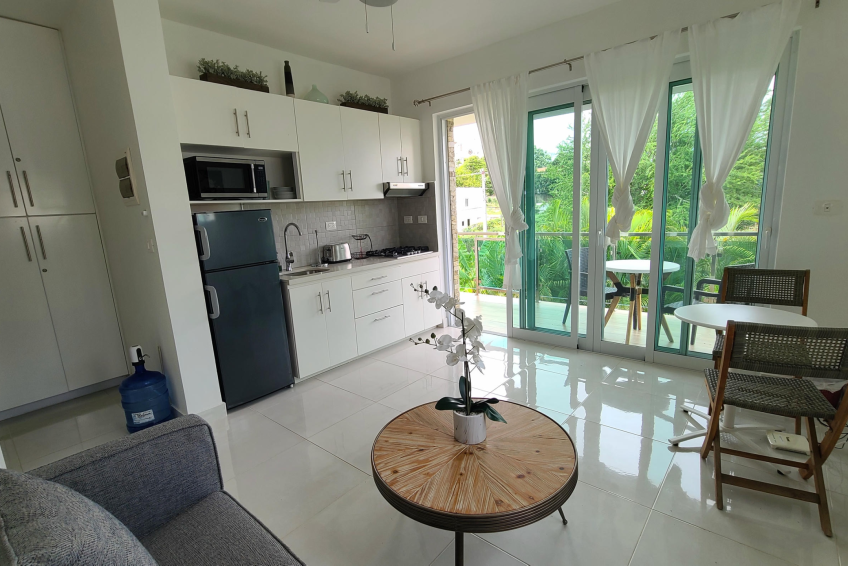 Open-concept living and kitchen space in Sosúa condos for sale with modern appliances and cozy layout