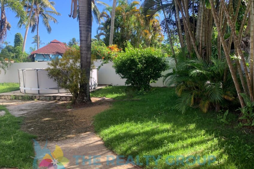 View of the garden of the fixer-upper in Cabarete East with walled lot