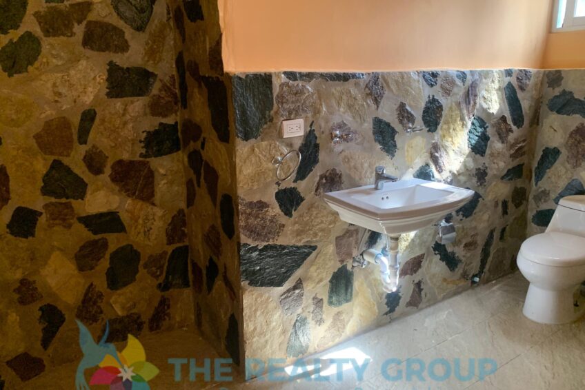 Bathroom in fixer-upper in Cabarete East with older style tiles