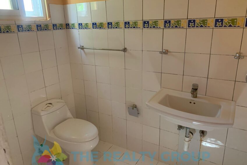 Bathroom in fixer-upper in Cabarete East with white tiles