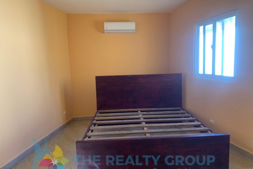 Bedroom with air conditioner in fixer-upper in Cabarete East