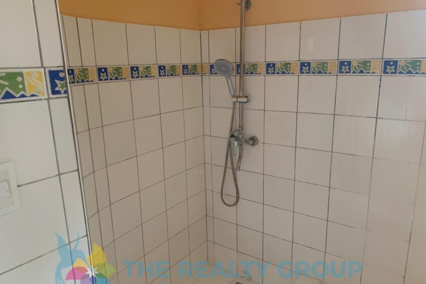 Bathroom in fixer-upper in Cabarete East with white tiles
