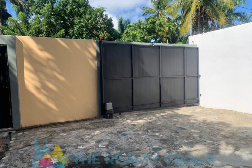View of gate fixer-upper in Cabarete East with walled lot