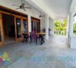 Covered terrace overlooking Bali-style pool and tropical garden at a beautiful villa with apartment and studio in Sosúa