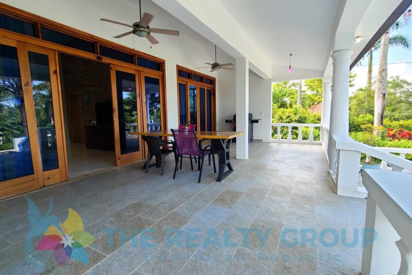 Covered terrace overlooking Bali-style pool and tropical garden at a beautiful villa with apartment and studio in Sosúa