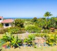 Luxury villa in Sosúa exterior with pool and gardens with ocean view.